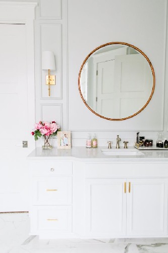 Add some brass details to your living room design round mirror